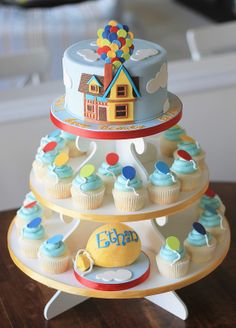 a three tiered cake stand with cupcakes on it