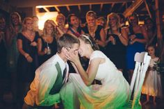 a bride and groom kissing on the dance floor