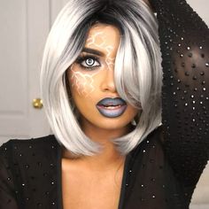 a woman with white hair and black makeup