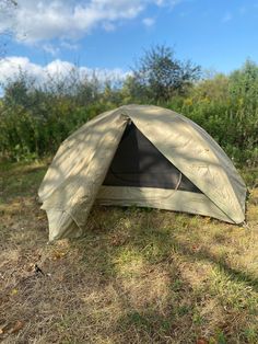 a tent sitting in the middle of a field