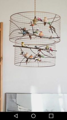 a chandelier with birds hanging from it's sides