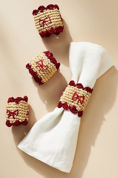 three napkins with red and white designs on them