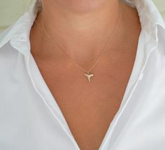 Gold Shark Tooth Pendant Necklace - Real Fossilized Tooth Our most popular single-layer shark tooth necklace! This simple, dainty gold shark tooth necklace is a must-have for any beach lover. The necklace features a real fossilized shark tooth found by Foxy Fossils in Charleston, SC making each one completely different and exclusive. The tooth is delicately hand-painted with several layers before placed on a dainty, elegant gold-filled chain that will not fade or tarnish over time. This necklace Shark Tooth Necklace Diy, Shark Tooth Necklace Gold, Shark Teeth Jewelry, Shark Jewelry, Shark Tooth Pendant, Tooth Charm, Tooth Pendant, Surf Jewelry, Shark Necklace