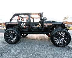 a black jeep parked on top of a parking lot