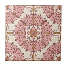 a pink and gold tile with an ornate design on the bottom, which is very similar to