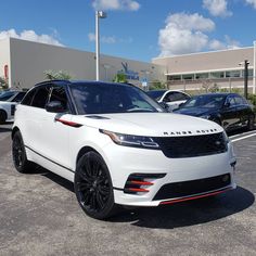 a white range rover parked in a parking lot