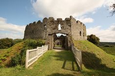 an old stone castle with a white gate