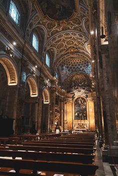 the interior of an old church with pews and stained glass on the ceiling,