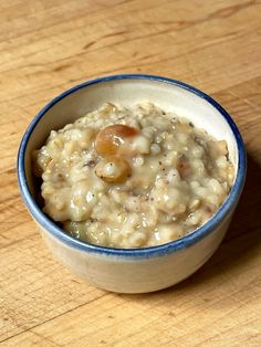 a bowl filled with oatmeal sitting on top of a wooden table