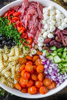 a bowl filled with different types of pasta salad