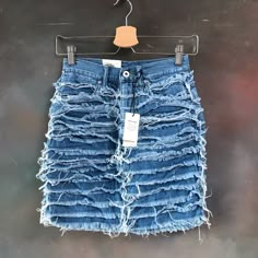 a pair of blue jean shorts hanging on a hanger