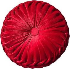 a red round pillow sitting on top of a white floor