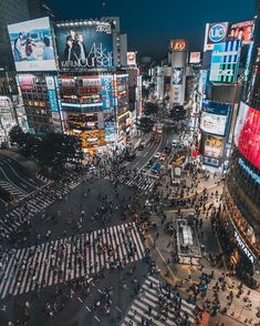 an aerial view of times square in new york city at night with people crossing the street