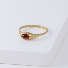 Description Hand-carved 14K yellow gold ring with a natural red garnet. Yui Ring embraces a graceful smoothness. She was made exactly for the Golden Hours - she’s confident, intelligent, poise and just entirely marvelous on her own. Not too loud, it shines just the right amount. Inspired by the nature, occasionally sweet pieces are often in organic shapes. The garnet gives a one-of-a-kind vivid red color to each ring. Details 14k Yellow GoldRed garnet - Approximately 2 x 3mm Made in U.S. *Please Red And Gold Ring, French Style Outfits, Handmade Gold Ring, Classic French Style, Too Loud, Nice Jewelry, Golden Ring, Ring Stack, Garnet Jewelry