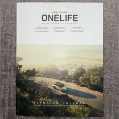 the front cover of a magazine with an image of a car driving down a road