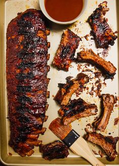 barbecue ribs and bbq sauce on a tray with text overlay that reads, fall off the bone dry rub ribs