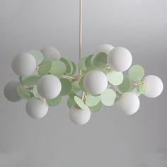 a green and white chandelier hanging from a ceiling