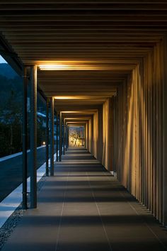 the walkway is lined with wooden slats and lit up by lights on either side