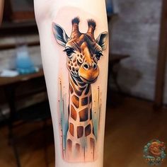 a giraffe tattoo on the right arm and leg, with watercolors