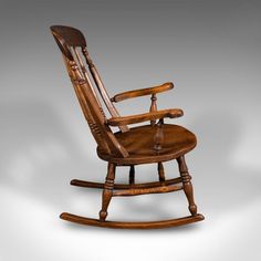 a wooden rocking chair on a white background with no one in it's seat