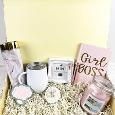 a gift box with candles, coffee mug and other items