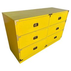 a yellow metal filing cabinet with four drawers on one side and two open file cabinets on the other