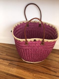 These beautiful pieces are designed in South Africa. Handmade with raffia and featuring leather handles, these bags bring the perfect mix of bohemian chic to everyday wear! Capable of being used as a handbag, basket or storage-this multi-purpose piece is a cannot miss! The double closure top provides a multi-style capability as well! Sizing: 16 inches wide x 12 inches deep x 13 inches high Bohemian Straw Bag With Bamboo Handle For Shopping, Bohemian Bucket Bag With Bamboo Handle In Natural Color, Bohemian Natural Bucket Bag With Bamboo Handle, Bohemian Shoulder Bag With Bamboo Handle For Shopping, Beach Bag With Bamboo Handles For Shopping, Beach Bag With Bamboo Double Handles For Shopping, Bohemian Bucket Bag With Bamboo Handle, Bohemian Crochet Bucket Bag With Leather Handles, Summer Straw Bag With Round Handle For Shopping