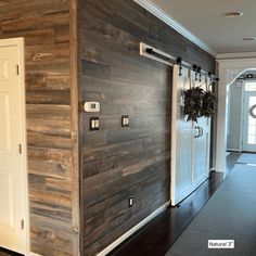 an entryway with wood paneling and white doors