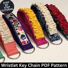 five key chains are lined up in different colors and patterns, with the words wristlet key chain pattern below them