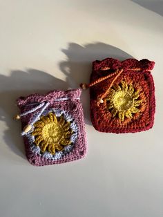 two small crocheted bags sitting next to each other