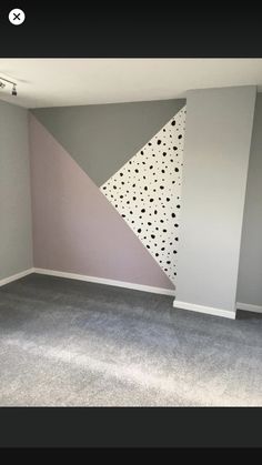 an empty room with some paint on the walls and carpeting in front of it