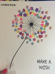 a hand holding up a card with a dandelion made out of confetti