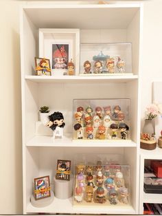 the shelves are filled with various figurines and pictures