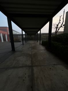 an empty walkway in front of a building