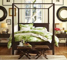 a bedroom with a canopy bed and two side tables