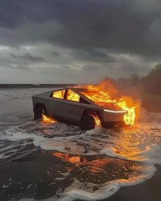 a car that is on fire in the water with it's doors open and flames coming out