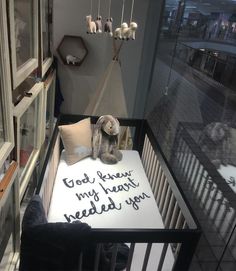 a teddy bear sitting on top of a bed in a room