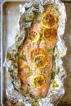 salmon with lemons and herbs on foil