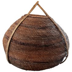 a woven basket is hanging from a wooden handle