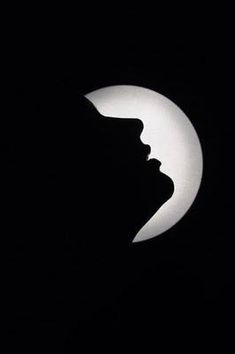 the silhouette of a woman's head is shown in front of a crescent moon