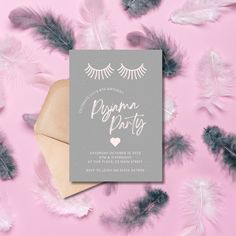 the wedding card is surrounded by feathers on a pink background with grey and white lettering