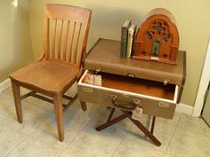 two wooden chairs sitting next to each other in front of a table with books on it