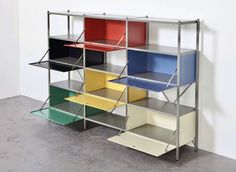 a multicolored shelving unit in an empty room