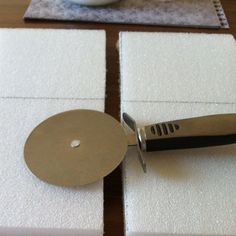 a knife is sitting on top of some placemats with white squares around it