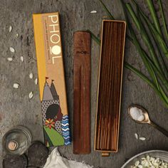 an assortment of food items including rice, spoons and chopsticks on a table