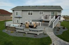 a house with a patio and hot tub in the yard