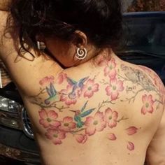 the back of a woman's body with flowers on it