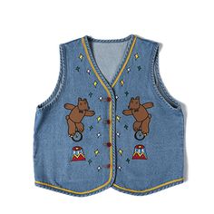 a child's denim vest with bears and stars on the chest, in front of a white background