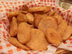 a basket filled with fried food on top of a table