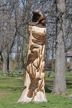 a carved wooden sculpture in the middle of a park